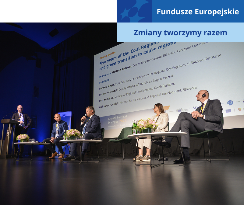 Zdjęcie przedstawia debatę w trakcie konferencji. Na scenie siedzi czterech ekspertów – trzech mężczyzn i kobieta. Jeden z mężczyzn przemawia do mikrofonu. Z boku stoi prowadzący. Autorem fotografii jest Dominik Wójcik.