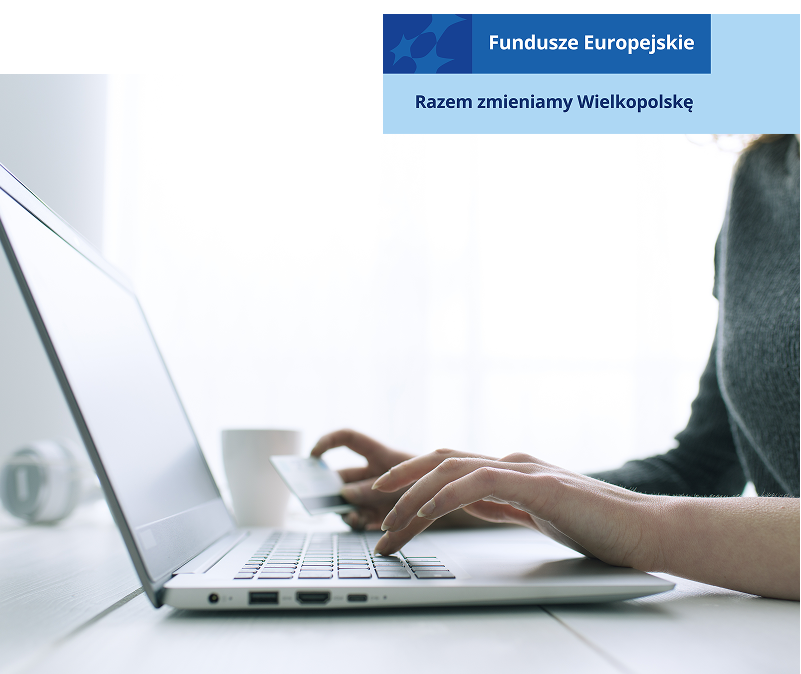 Fotografia przedstawia ręce kobiety, która dokonuje jakiejś operacji za pomocą laptopa i dowodu osobistego. Zdjęcie pochodzi z adobe stock.