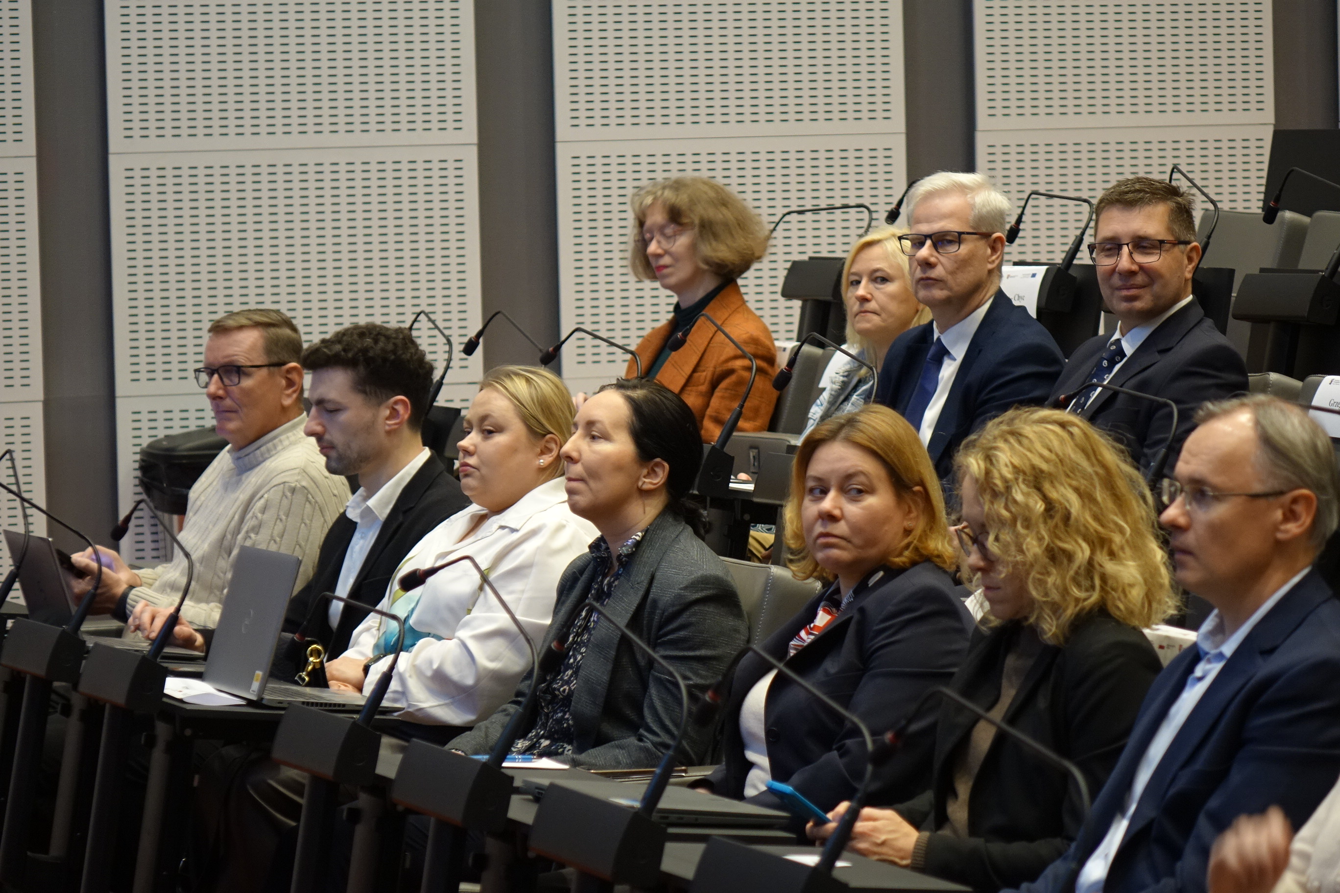 Kilkanaście osób siedzących na widowni 