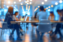 grupa osób siedzi w sali przy stole